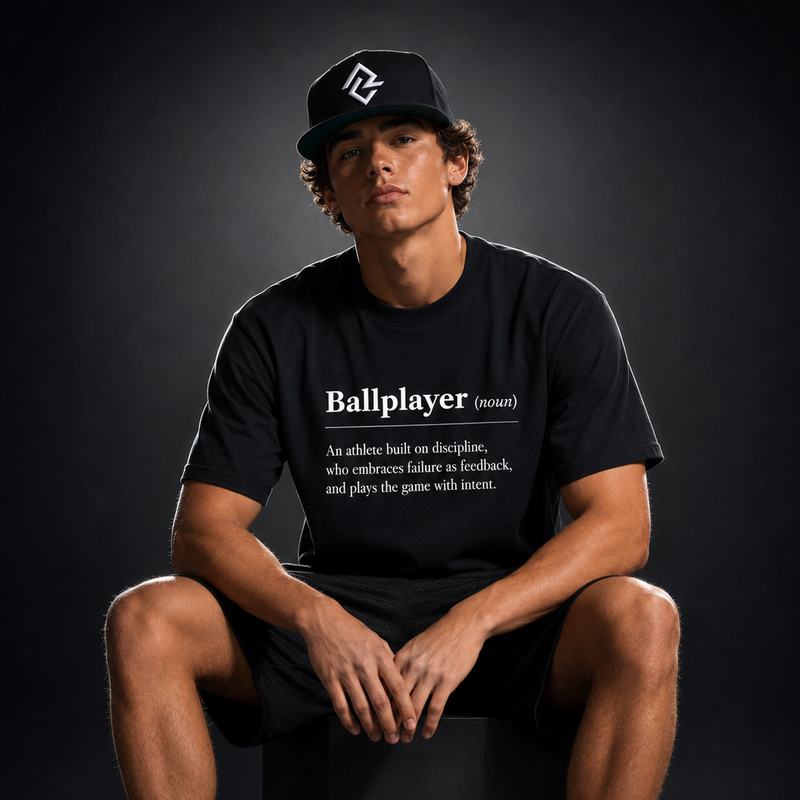 Model wearing the BALLPLAYER premium baseball t-shirt and Rake City snapback hat by Rake City.
