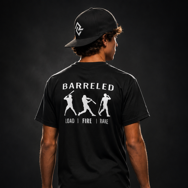 Model wearing the black BARRELED premium baseball t-shirt and black Rake City RC snapback.
