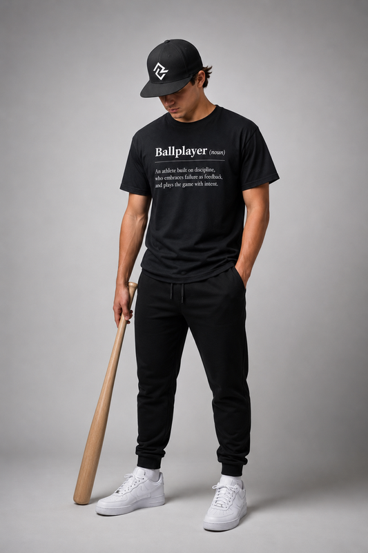Model wearing the black BALLPLAYER t-shirt and black RC snapback by Rake City.