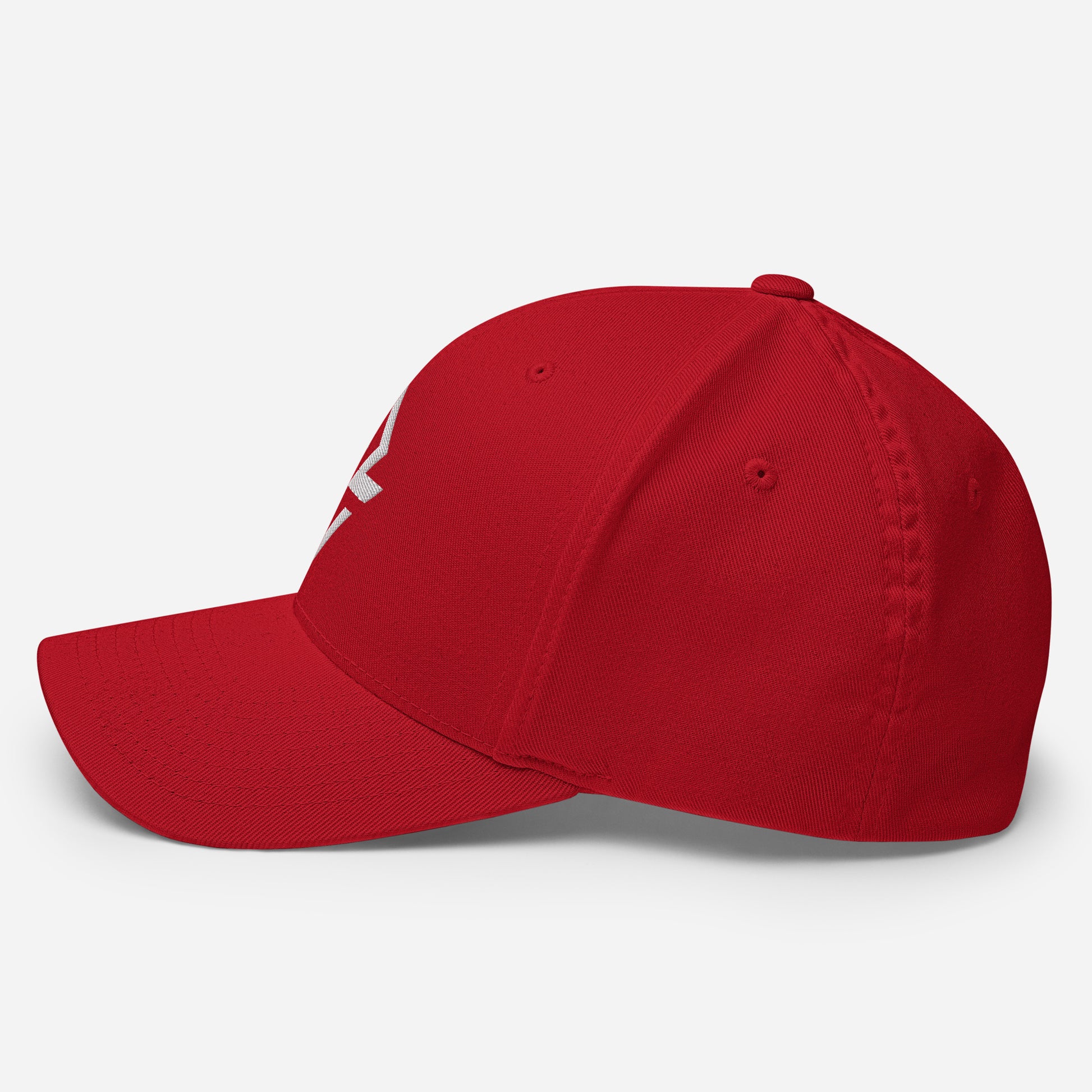 Profile view of the red flexfit baseball hat by Rake City.