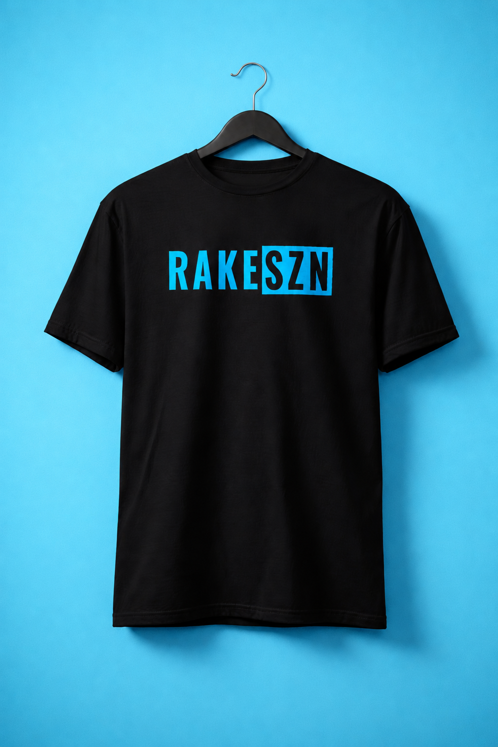 Hanger view of the black RAKESZN premium baseball t-shirt by Rake City.