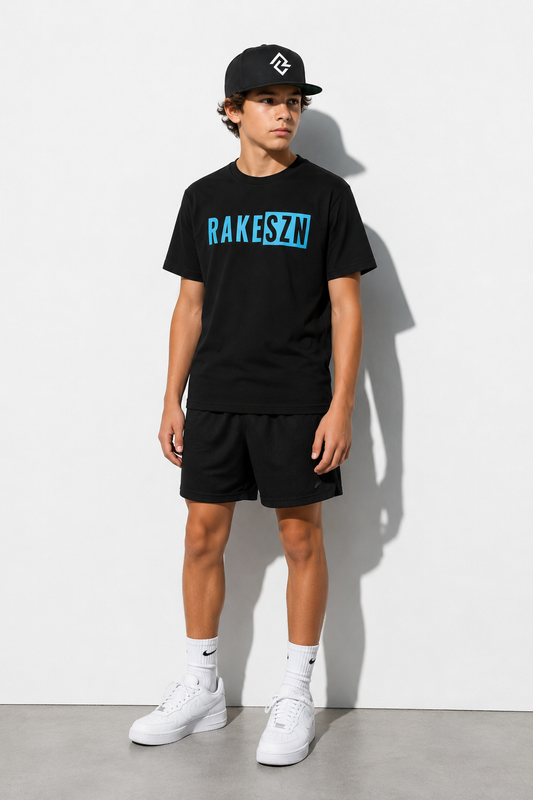 Model wearing the youth black RAKESZN t-shirt and black RC snapback by Rake City.