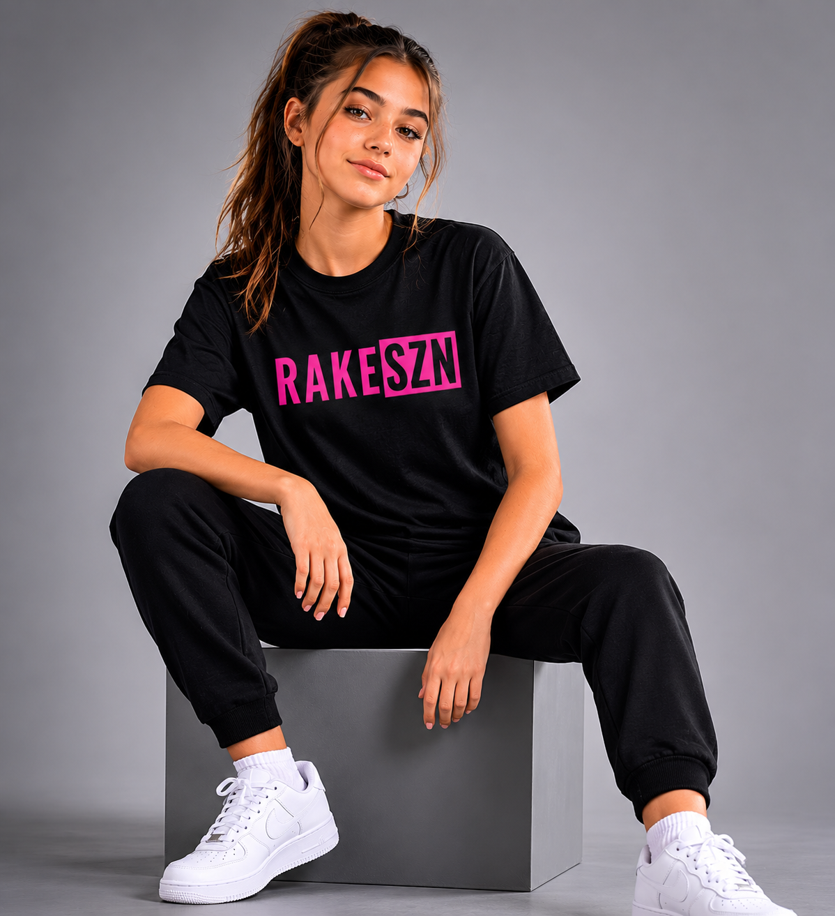 Model wearing the black RAKE SZN t-shirt by Rake City.