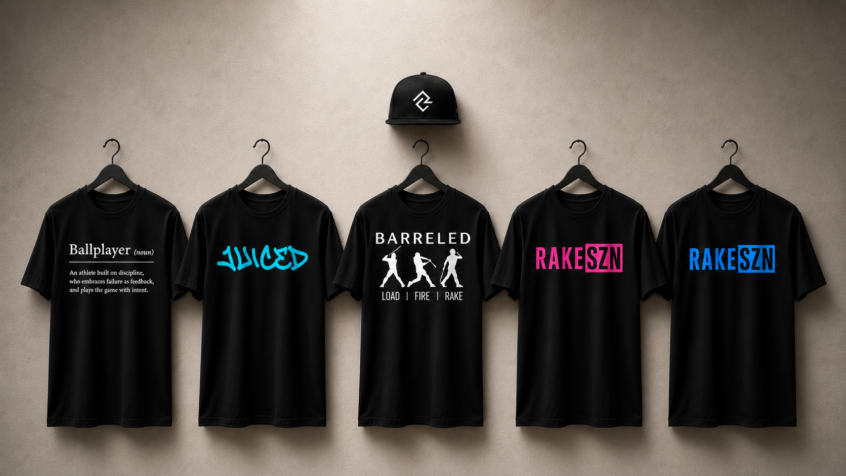 View of the Rake City collection, including the BALLPLAYER, JUICED, BARRELED, and RAKE SZN t-shirts and RC Rake City Snapback hat.