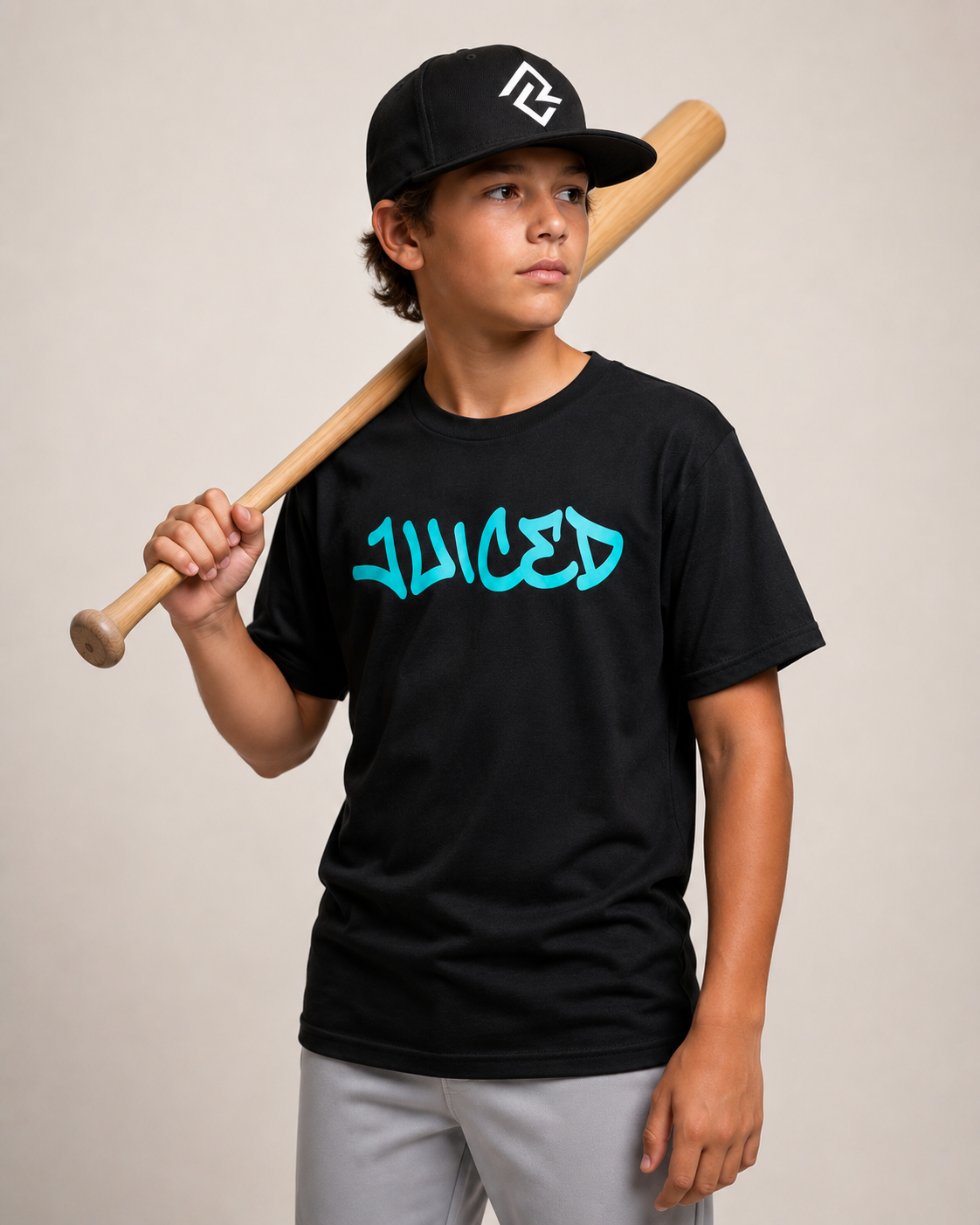 Model wearing the youth JUICED premium baseball t-shirt and RC logo snapback hat.