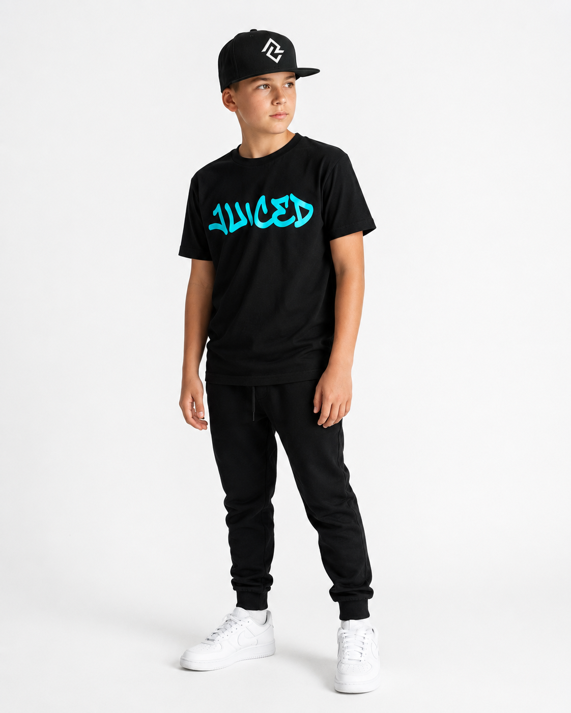 Model wearing the youth JUICED premium baseball t-shirt and RC logo snapback hat.